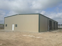 Tan 60x120x16 steel building kit with green roof, side windows, and concrete slab foundation on dirt ground. — supplier listing reference; configuration may vary.